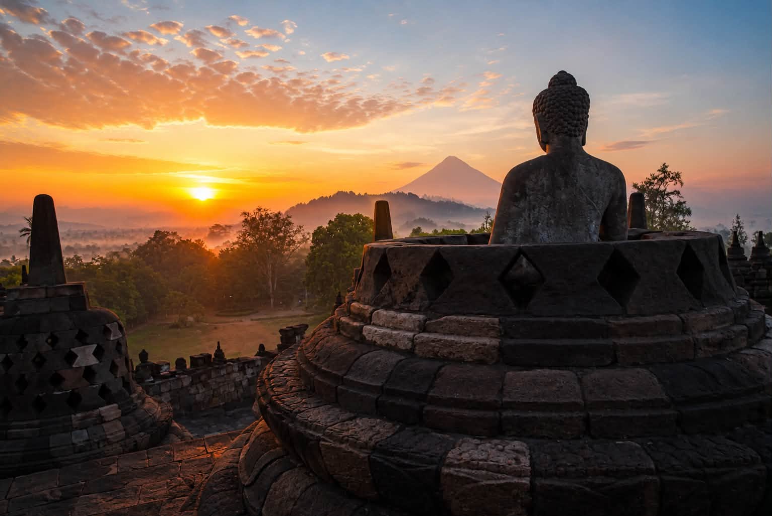 A Buddha statue at Borobudur at sunrise